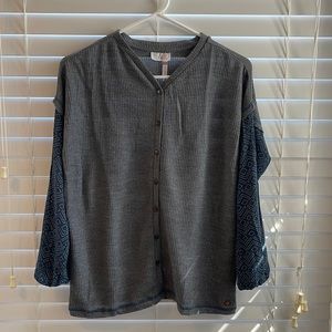 The brand is Matilda Jane. The size is a 14. It is Gray and navy button up.
